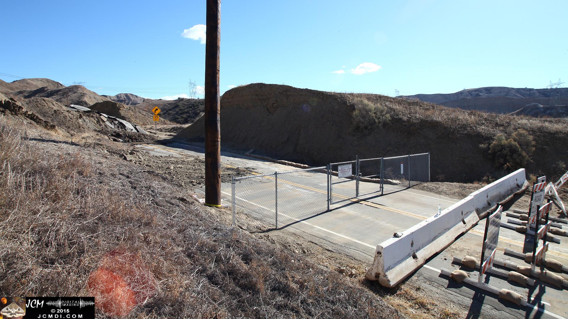 Landslide, buckled pavement, and terrain at Vasquez Canyon Road in Santa Clarita, CA filmed 11-25-2015